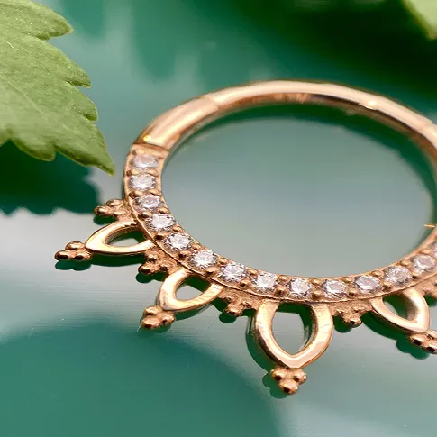 golden jewelry on display over green background